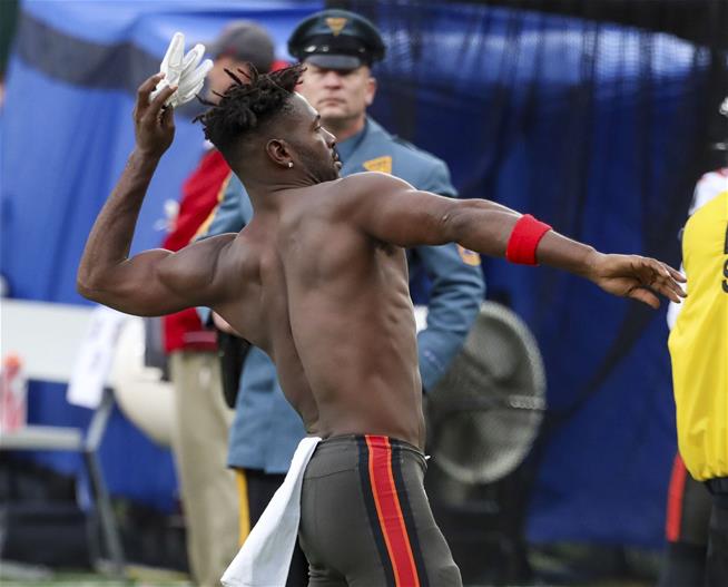 Antonio Brown throws his gloves into the crowd after leaving the team 