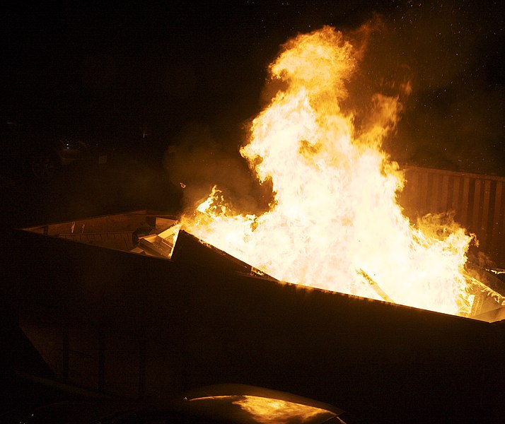 A dumpster that is burning